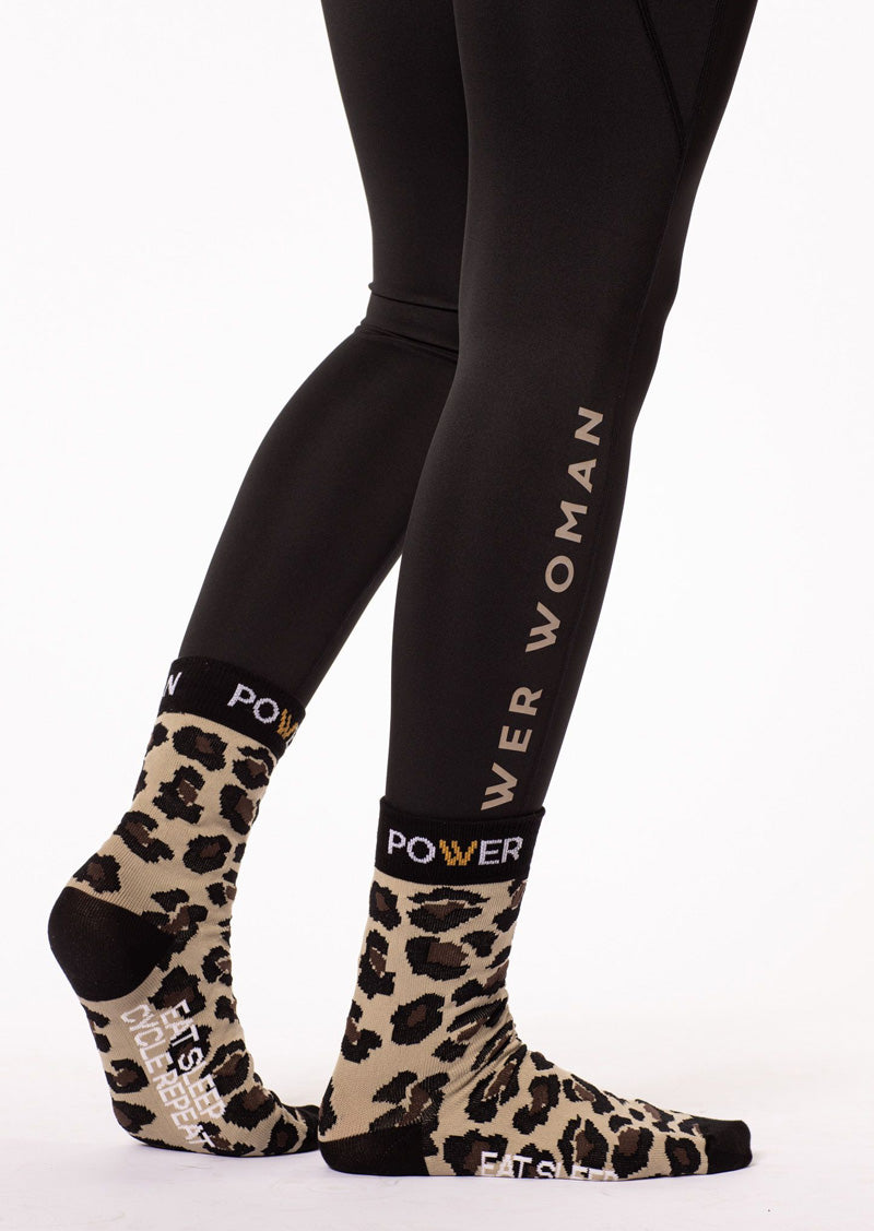 Medium height Bike Sock by Power Woman in Gold Leo Collection. A high quality bike sock with the perfect fit. The sock has the empowering quote "Eat Sleep Cycle Repeat" and is made in the well-known Power Woman Leo pattern. Use during your cycling session or competition for extra comfort. Made in Sweden